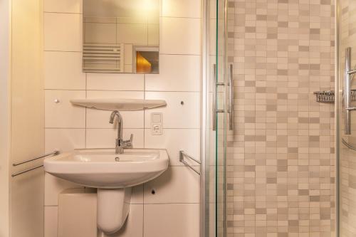a bathroom with a sink and a shower at 50041 Muschelbank in Harlesiel