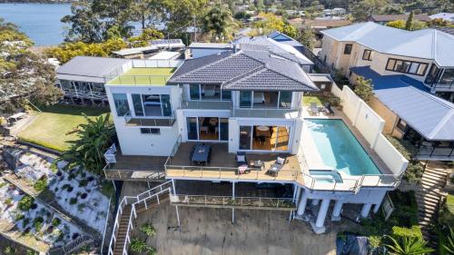 an aerial view of a house with a swimming pool at Waters Edge - Point Clare - Pool , Spa, Private Jetty in Point Clare