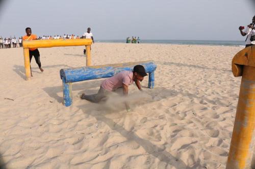 a man playing in the sand on the beach at Bojo Beach Resort in Bortianor