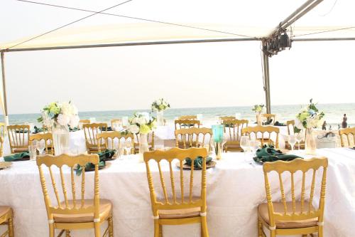 a table set up for a wedding at the beach at Bojo Beach Resort in Bortianor