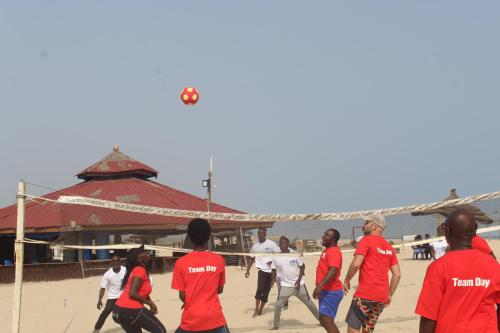 a group of people playing volleyball on the beach at Bojo Beach Resort in Bortianor