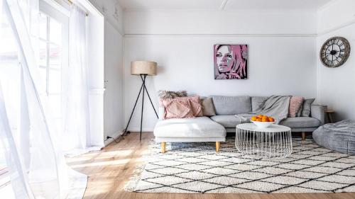 a living room with a couch and a table at Bangalow Beach House - Ettalong, pet friendly, walk to beach,shops,cafes in Ettalong