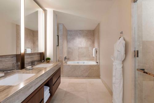 a bathroom with two sinks and a shower and a tub at Park Hyatt Chicago in Chicago