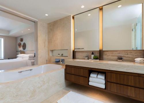 a bathroom with a tub and a bed and a mirror at Park Hyatt Chicago in Chicago