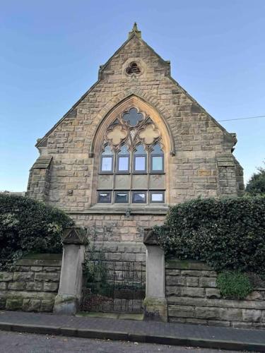 a stone building with a window on top of it at Chapter Two - Melbourne in Melbourne