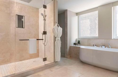 a bathroom with a bath tub and a shower at Park Hyatt Chicago in Chicago