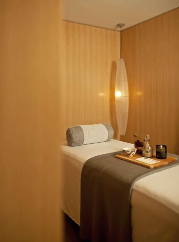 a hotel room with two beds and a tray of food at Park Hyatt Chicago in Chicago