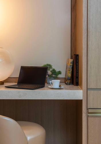a desk with a laptop and a cup on it at Park Hyatt Chicago in Chicago