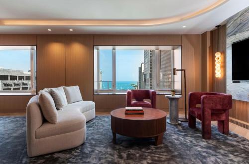 a living room with a couch and chairs and a table at Park Hyatt Chicago in Chicago