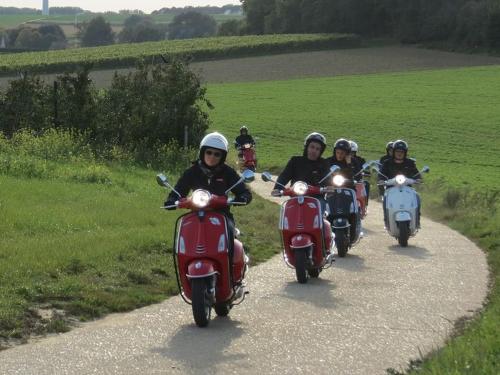 a group of people riding motorcycles down a road at Vakantiewoning Hoogveld in Kortessem