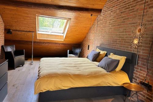 En eller flere senge i et værelse på Vakantiewoning Hoogveld