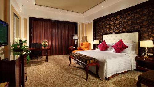 a bedroom with a large bed with red pillows at Wyndham Grand Plaza Royale Palace Chengdu in Chengdu