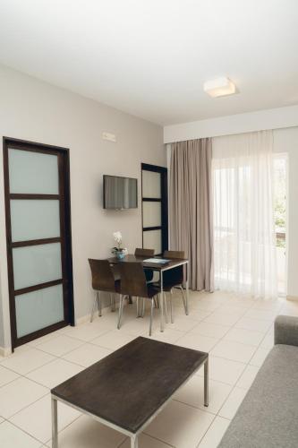 a living room with a table and a desk at Corinna Mare in Kalamaki Chanion