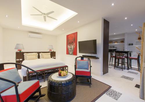 a bedroom with a bed and a living room at Bungalow VILLA Rumba in Ko Yao Noi