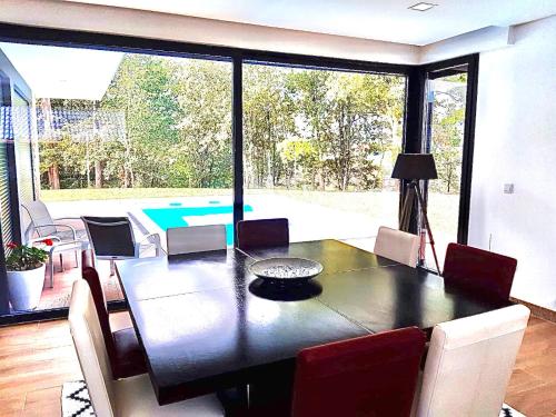 a dining room with a table and a pool at Casa tapada da cheda 1 in Fafe