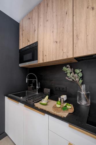 a kitchen with white cabinets and a counter top at Osada Widokowa Kościelisko in Kościelisko