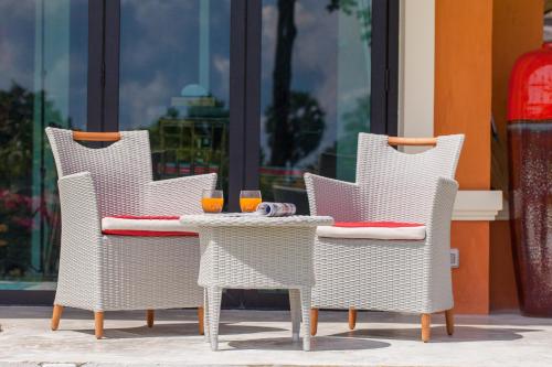 three chairs and a table with drinks on it at Bungalow VILLA Rumba in Ko Yao Noi