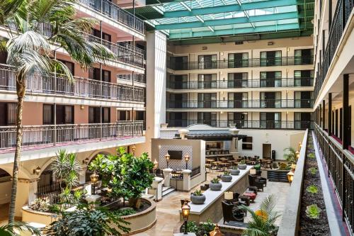 an image of the lobby of a hotel with palm trees at Embassy Suites by Hilton Los Angeles International Airport South in El Segundo