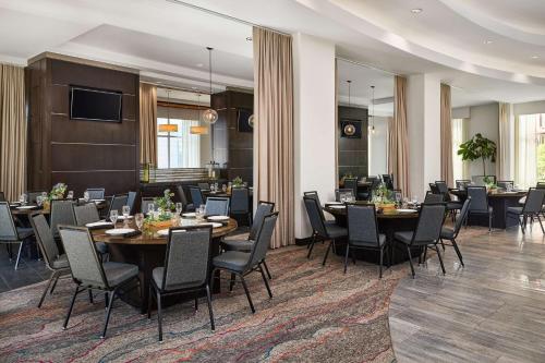 a conference room with tables and chairs and a television at Hilton Garden Inn Nashville Downtown Convention Center in Nashville