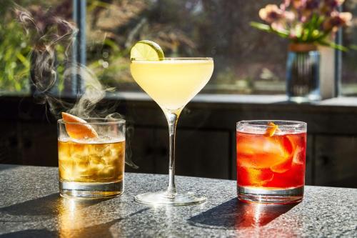 three cocktails sitting on top of a table at Hilton Garden Inn Nashville Downtown Convention Center in Nashville