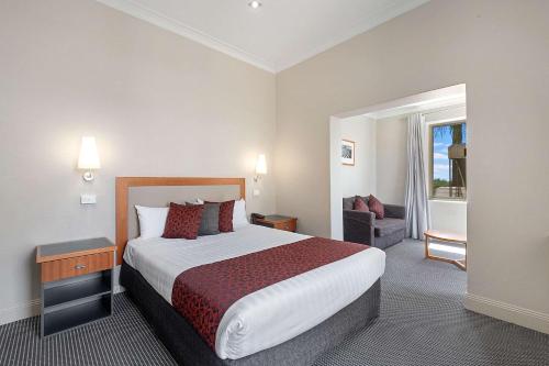 a hotel room with a large bed and a window at Quality Hotel Mildura Grand in Mildura