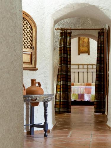 a room with a table with a vase on it at Cuevas Pedro Antonio de Alarcon in Guadix