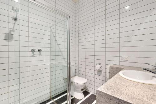a bathroom with a shower and a toilet and a sink at Quality Hotel Mildura Grand in Mildura