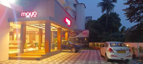 a car parked in front of a mazda dealership at Mayo Suites in Palakkad