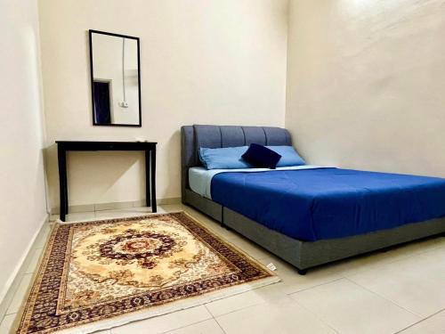 a bedroom with a bed and a mirror and a rug at Rumah Mok Aji Homestay Melaka in Melaka