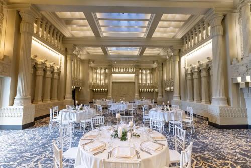 a banquet hall with white tables and chairs at Hotel Maison Yakima Tapestry Collection by Hilton in Yakima
