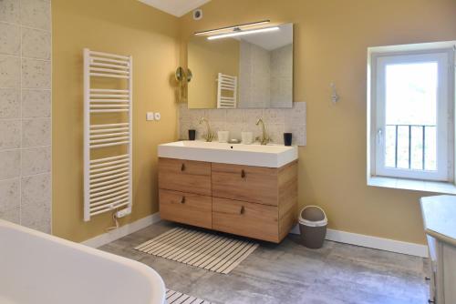 a bathroom with a sink and a mirror at La Chartreuse d'Ertan "Les vignerons" 4 étoiles in Saint-Christophe-des-Bardes