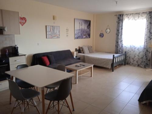 a living room with a couch and a table at Xylophagou Rest and Relax 3 Ayia Napa Larnaca 1 bedroom apartment in Xylophaghou