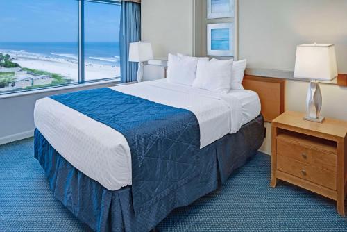 um quarto de hotel com uma cama e uma grande janela em Hilton Vacation Club Daytona Beach Regency em Daytona Beach