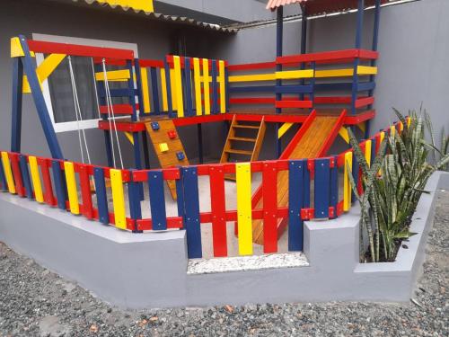 a toy house with colorful wooden barricades on it at Gravatá Praia Hotel- Frente ao mar in Navegantes