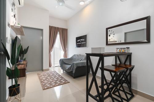 a living room with a table and a mirror at Gombak Homestay at Ayuman Suites Kuala Lumpur in Kampong Kerdas