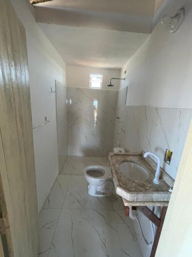 a bathroom with a toilet and a sink at Casa Marina in Camocim