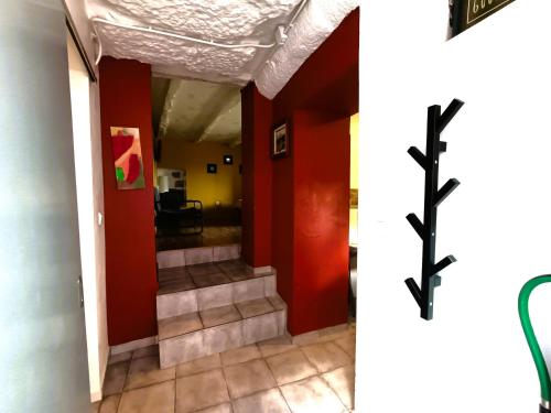 a hallway with red walls and a cross on the wall at Bonjoia Apartments in Porto
