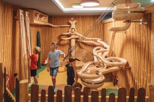 a group of children playing in a playground at Familienhotel Huber in Valles