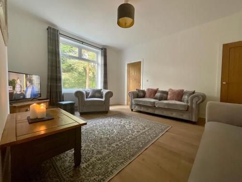 a living room with a couch and a table at Rosie's Cottage - Beamish in Beamish