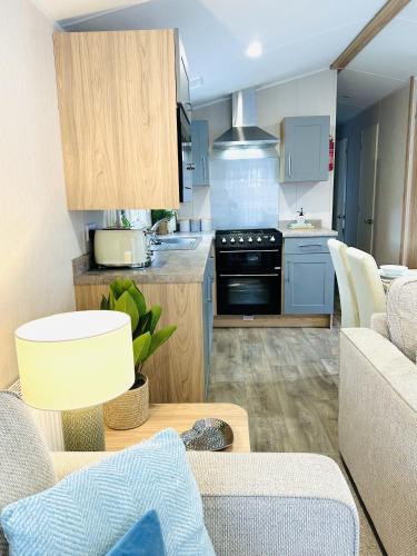 a kitchen and living room with a couch and a table at Beach Grove in Scarborough