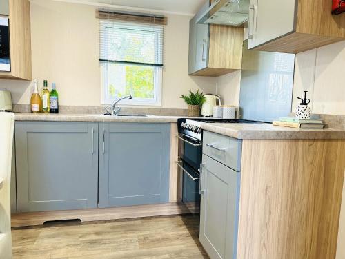 a kitchen with blue cabinets and a sink at Beach Grove in Scarborough