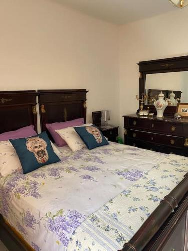 a bedroom with a bed with pillows on it at Cà Rara pied à terre in Marina di Carrara