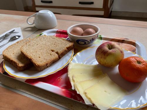a tray with bread and apples and eggs on a table at Studio famille, lit aventurier in Saint-Laurent-de-Neste