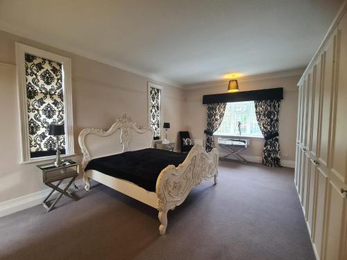 a bedroom with a white bed and a window at 23 HeadsLane in Hessle