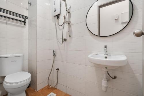 uma casa de banho com um WC, um lavatório e um espelho. em Gombak Homestay at Ayuman Suites Kuala Lumpur em Kampong Kerdas