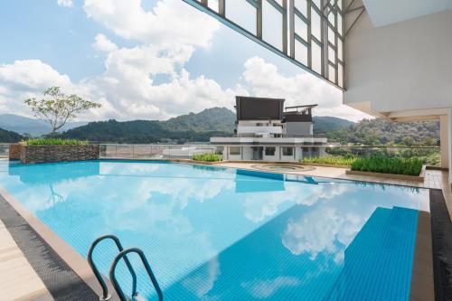 a swimming pool with a view of a building at Gombak Homestay at Ayuman Suites Kuala Lumpur in Kampong Kerdas