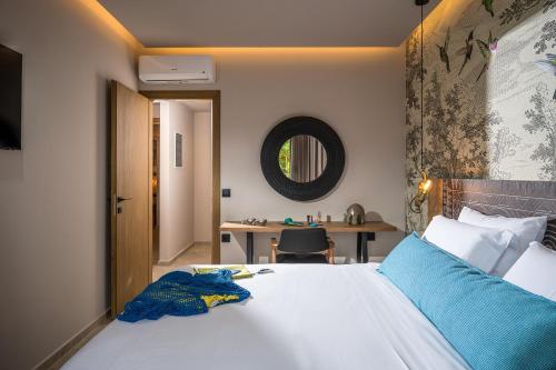 a bedroom with a large bed and a desk at Grace Villas Collection in Hersonissos