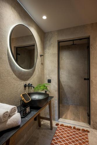 a bathroom with a sink and a mirror at Grace Villas Collection in Hersonissos