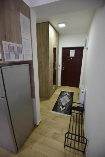 a hallway with a door and a chair in a room at Studio 13 in Kragujevac
