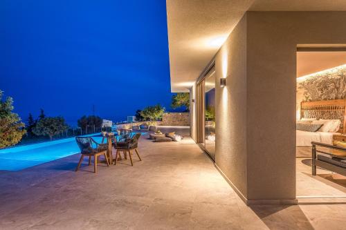 a villa with a swimming pool at night at Grace Villas Collection in Hersonissos